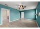 Spacious bedroom with luxury vinyl plank floors, ceiling fan, and multiple entryways at 3120 Areca Ave, New Smyrna Beach, FL 32168
