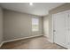 A quaint bedroom with wood floors, natural light and a neutral color scheme creates a warm, inviting space at 3120 Areca Ave, New Smyrna Beach, FL 32168