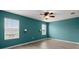 This bedroom boasts a ceiling fan, two windows with blinds, and luxury vinyl plank flooring at 3120 Areca Ave, New Smyrna Beach, FL 32168