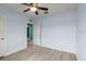 Bedroom features wood-look flooring, a ceiling fan, and an ensuite bathroom at 3120 Areca Ave, New Smyrna Beach, FL 32168