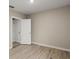 Neutral bedroom offers wood floors, a single window and a door to the attached bathroom at 3120 Areca Ave, New Smyrna Beach, FL 32168
