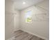Walk-in closet that is equipped with wire shelving and a window providing natural light at 3120 Areca Ave, New Smyrna Beach, FL 32168
