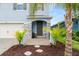 Charming entrance to a two-story home with stone accents and lush landscaping at 3120 Areca Ave, New Smyrna Beach, FL 32168