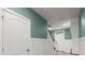 Lovely entryway showing the front door, stairs with white banister, and a teal accent wall at 3120 Areca Ave, New Smyrna Beach, FL 32168