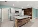 View of the kitchen with granite countertops, a large island with wood accents and stainless steel appliances at 3120 Areca Ave, New Smyrna Beach, FL 32168