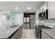 Modern kitchen with stainless steel appliances, granite countertops, tile backsplash and an island at 3120 Areca Ave, New Smyrna Beach, FL 32168