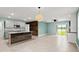Open living room with tiled floors, center island, and stainless steel appliances at 3120 Areca Ave, New Smyrna Beach, FL 32168