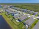 Aerial view of a neighborhood featuring well-manicured lawns and a serene pond at 3128 Crab Trap Dr, New Smyrna Beach, FL 32168