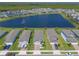 Stunning aerial view of a lakefront community with well-maintained homes and lush landscaping at 3128 Crab Trap Dr, New Smyrna Beach, FL 32168