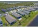 An aerial view showcases houses near a lake with manicured lawns at 3128 Crab Trap Dr, New Smyrna Beach, FL 32168