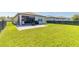 A well-maintained backyard features a patio, green lawn, and a swing set at 3128 Crab Trap Dr, New Smyrna Beach, FL 32168