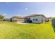 A spacious backyard with a lush green lawn and patio space for outdoor entertaining at 3128 Crab Trap Dr, New Smyrna Beach, FL 32168