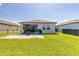 A well-maintained backyard features a patio and a lush green lawn at 3128 Crab Trap Dr, New Smyrna Beach, FL 32168
