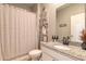 Well-maintained bathroom featuring a granite vanity, decorative shelves, and a shower-tub combo at 3128 Crab Trap Dr, New Smyrna Beach, FL 32168