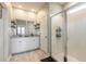 The bathroom offers a dual sink vanity and a glass-enclosed shower with tiled walls and shelving at 3128 Crab Trap Dr, New Smyrna Beach, FL 32168