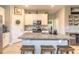 Well-lit kitchen featuring a large island, stainless steel appliances, granite counters, and white cabinets at 3128 Crab Trap Dr, New Smyrna Beach, FL 32168