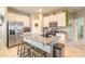 Bright kitchen featuring granite counters, stainless steel appliances, white cabinets and a central island with breakfast bar at 3128 Crab Trap Dr, New Smyrna Beach, FL 32168