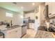 Modern kitchen features granite countertops, stainless steel appliances, white cabinetry, and stainless steel dishwasher at 3128 Crab Trap Dr, New Smyrna Beach, FL 32168