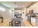 Modern kitchen featuring granite countertops, stainless steel appliances, white cabinetry, and a central island with seating at 3128 Crab Trap Dr, New Smyrna Beach, FL 32168