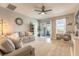 Living room featuring modern fan, sliding glass door, plush furnishings, and views of the outdoors at 3128 Crab Trap Dr, New Smyrna Beach, FL 32168
