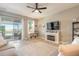 The cozy living room features comfortable seating, fireplace, and sliding glass doors to a covered patio at 3128 Crab Trap Dr, New Smyrna Beach, FL 32168