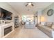 Open-concept living room featuring a fireplace with mounted television, modern furnishings, and an adjoining dining area at 3128 Crab Trap Dr, New Smyrna Beach, FL 32168