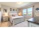 Cozy main bedroom featuring a large bed, two windows and natural light at 3128 Crab Trap Dr, New Smyrna Beach, FL 32168