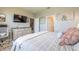 Comfortable main bedroom featuring an accent wall with personalized decor above a decorative dresser with a large flat screen television at 3128 Crab Trap Dr, New Smyrna Beach, FL 32168