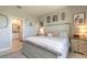 The cozy main bedroom features a decorative headboard, coordinated bedside tables, and en-suite bathroom access at 3128 Crab Trap Dr, New Smyrna Beach, FL 32168