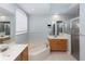 Bright bathroom has dual vanities, a soaking tub, glass enclosed shower, and lots of light at 316 Oak Springs Dr, Debary, FL 32713