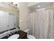 Updated bathroom features a vanity with a black countertop and a shower with a patterned curtain at 316 Oak Springs Dr, Debary, FL 32713