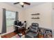 A cozy bedroom is furnished with a computer, chair, shelves and a bookcase at 316 Oak Springs Dr, Debary, FL 32713
