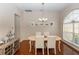 Elegant dining room featuring hardwood floors, natural light, and a charming chandelier, enhancing the space at 316 Oak Springs Dr, Debary, FL 32713