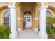 Inviting front porch with decorative wreath and supporting columns, creating a welcoming entrance at 316 Oak Springs Dr, Debary, FL 32713