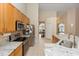 Bright kitchen boasts granite countertops, stainless steel appliances, and light brown cabinets at 316 Oak Springs Dr, Debary, FL 32713