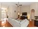 Large living room with hardwood floors, sectional couch, high ceiling, and arched doorway, offers ample space at 316 Oak Springs Dr, Debary, FL 32713