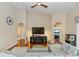 Open-concept living room with vaulted ceiling, hardwood floors, entertainment center, and view to adjacent rooms at 316 Oak Springs Dr, Debary, FL 32713