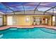 Relaxing screened-in pool area features a large pool and an outdoor seating area at 316 Oak Springs Dr, Debary, FL 32713