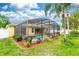 A refreshing screened-in pool surrounded by lush landscaping, offering a private oasis for relaxation and entertainment at 316 Oak Springs Dr, Debary, FL 32713