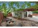 Backyard with a custom pizza oven, fire pit, covered patio and lush landscaping at 3267 Wild Pepper Ct, Deltona, FL 32725