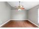 Spacious bedroom featuring hardwood floors, neutral wall color, a ceiling fan, and natural light from the window at 3267 Wild Pepper Ct, Deltona, FL 32725