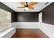 Bedroom featuring dark walls, hardwood floors, and a wooden fan at 3267 Wild Pepper Ct, Deltona, FL 32725