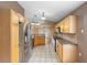 Kitchen features light wood cabinets, stainless steel appliances, and access to a bright dining area at 3267 Wild Pepper Ct, Deltona, FL 32725
