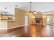 Inviting living room features a stone fireplace, hardwood floors, and a ceiling fan for comfort and style at 3267 Wild Pepper Ct, Deltona, FL 32725