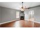 Living room with hardwood floors, a fireplace, and a ceiling fan at 3267 Wild Pepper Ct, Deltona, FL 32725
