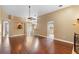 Spacious living area featuring hardwood floors, a decorative fountain, and arched doorways leading to other rooms at 3267 Wild Pepper Ct, Deltona, FL 32725