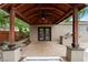A covered outdoor patio with a built-in grill area and stone pavers, perfect for entertaining at 3267 Wild Pepper Ct, Deltona, FL 32725