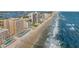 Panoramic aerial view of oceanfront condos, a sandy beach, and a serene coastal community at 3799 S Atlantic Ave # 601, Daytona Beach, FL 32118