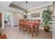 Lovely dining area with chandelier, wood table and seating for six, plus adjacent decorative plant at 3799 S Atlantic Ave # 601, Daytona Beach, FL 32118