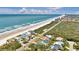 Panoramic aerial view showcases beachfront homes, coastline, and ocean, perfect for coastal living at 4363 S Atlantic Ave, Ponce Inlet, FL 32127